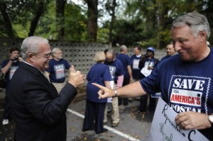 Rep. Gerald Connolly, left, talks with Ernie Kirkland of NALC at a rally in Annandale, Va.