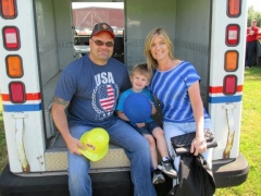 Review Photo/ERIC HRIN Gary and Karen Wilcox of Towanda sit with grandson Carter Wright, 4, of Sayre, in a postal truck at the "Touch a Truck" event Sunday at the Bradford County Airport