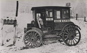 Rural_carrier_in_automobile_at_mailboxes,_c.1910