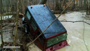 Georgia mail carrier rescued after vehicle swept away by flooding creek
