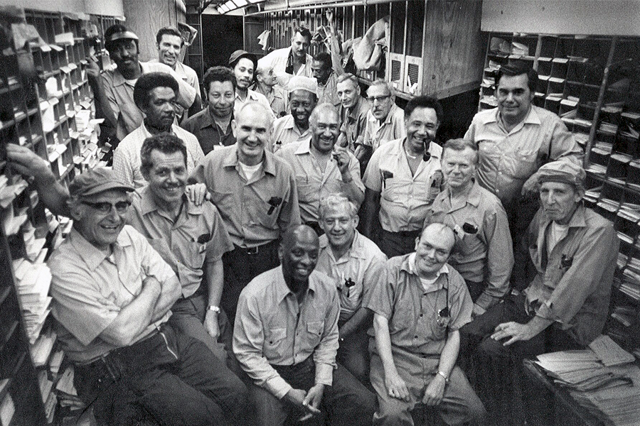 The New York and Washington Railway Post Office (RPO) crew gathers on a train before departing on its final run. These clerks worked in two adjacent 60-foot RPO cars. The final trip was June 30, 1977.