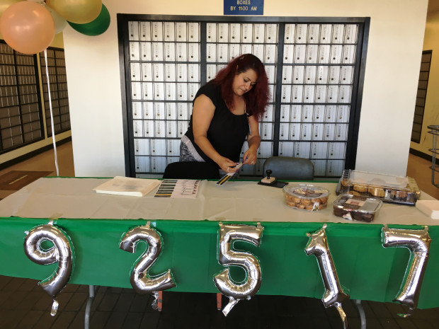 Julie Aguero, retail supervisor at the Chicago Avenue post office in Riverside, prepares a commemorative 92517-postmarked envelope on Monday, Sept. 25, 2017, for a Date Meets ZIP celebration. The U.S. Postal Service issues special postmarks for collectors when a zip code matches the date. (SUZANNE HURT, STAFF PHOTO/SCNG)
