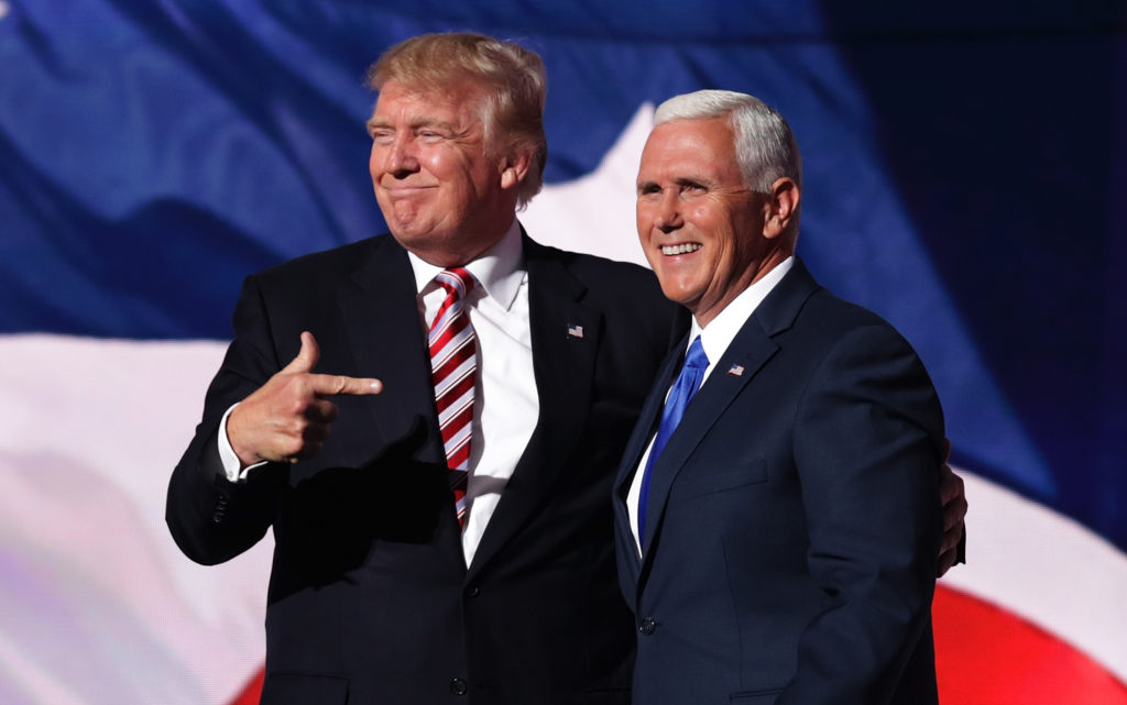 CLEVELAND, OH - JULY 20: Republican presidential candidate Donald Trump stands with Republican vice presidential candidate Mike Pence and acknowledge the crowd on the third day of the Republican National Convention on July 20, 2016 at the Quicken Loans Arena in Cleveland, Ohio. Republican presidential candidate Donald Trump received the number of votes needed to secure the party's nomination. An estimated 50,000 people are expected in Cleveland, including hundreds of protesters and members of the media. The four-day Republican National Convention kicked off on July 18. (Photo by Chip Somodevilla/Getty Images)